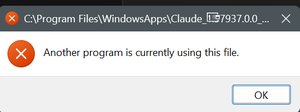 A Windows dialog reading: Another program is currently using this file.